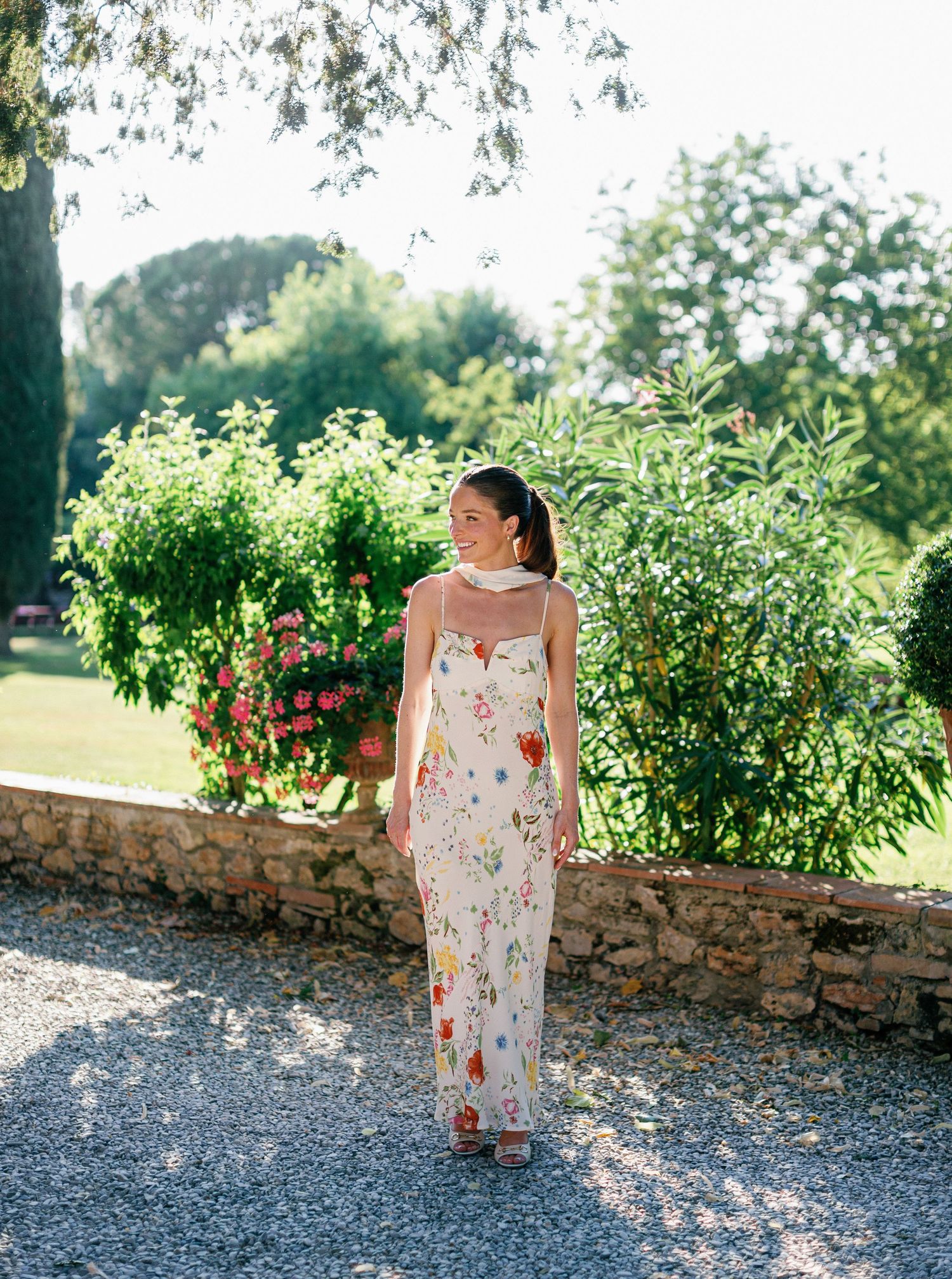 Bride to be posing in a lush garden backdrop at Borgo San Luigi.