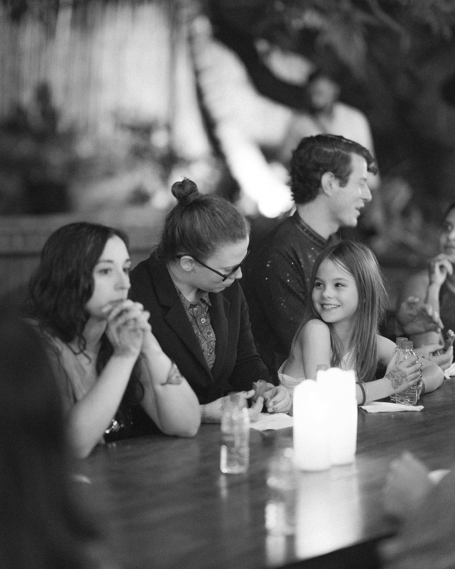Black & white shot of wedding guests at candlelit reception tables by the best wedding photographer in London & Birmingham.