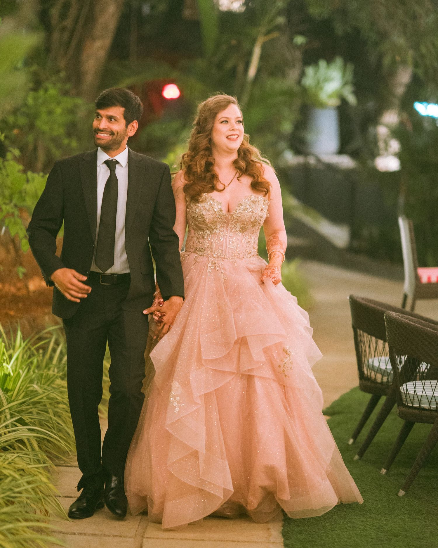Thought processCouple sitting outdoors in formal attire with a pink ballgown & dark suit by the best wedding photographer in London
