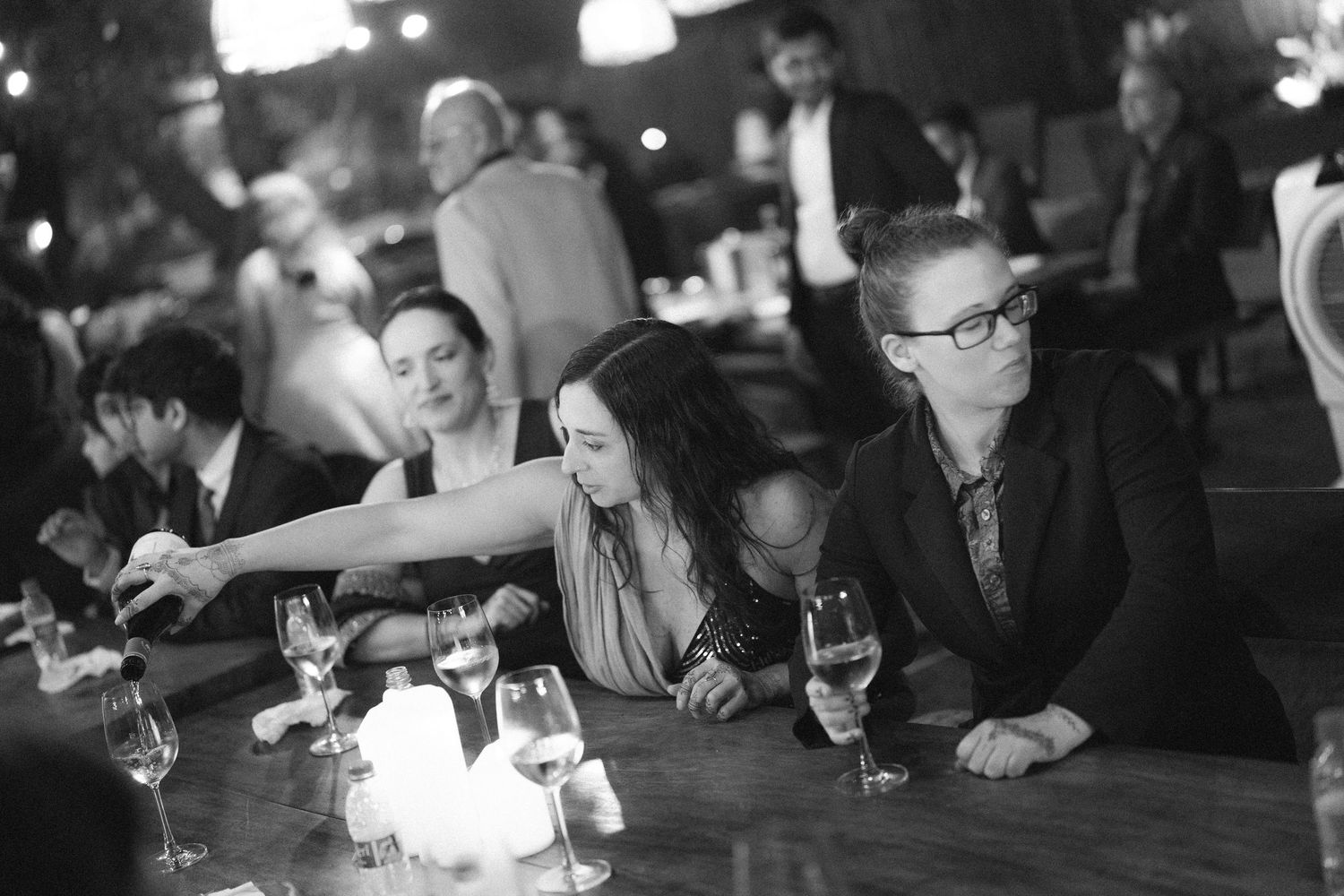Wedding guests enjoying a nighttime celebration with ambient lighting and festive atmosphere by best wedding photographer in London