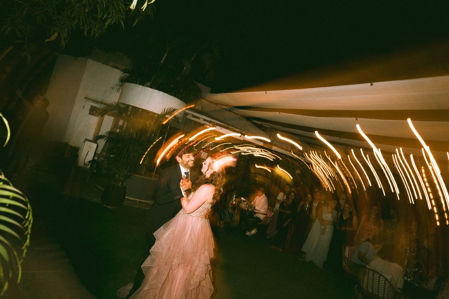Dimly lit wedding reception venue with hanging lights creating an intimate atmosphere by the best wedding photographer in London.