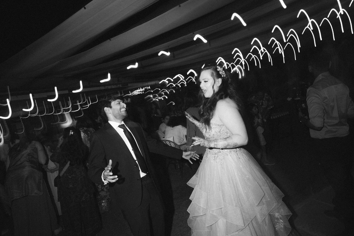 Wedding celebration dancing under decorative lights creating ceiling patterns by a wedding photographer in London & Birmingham.