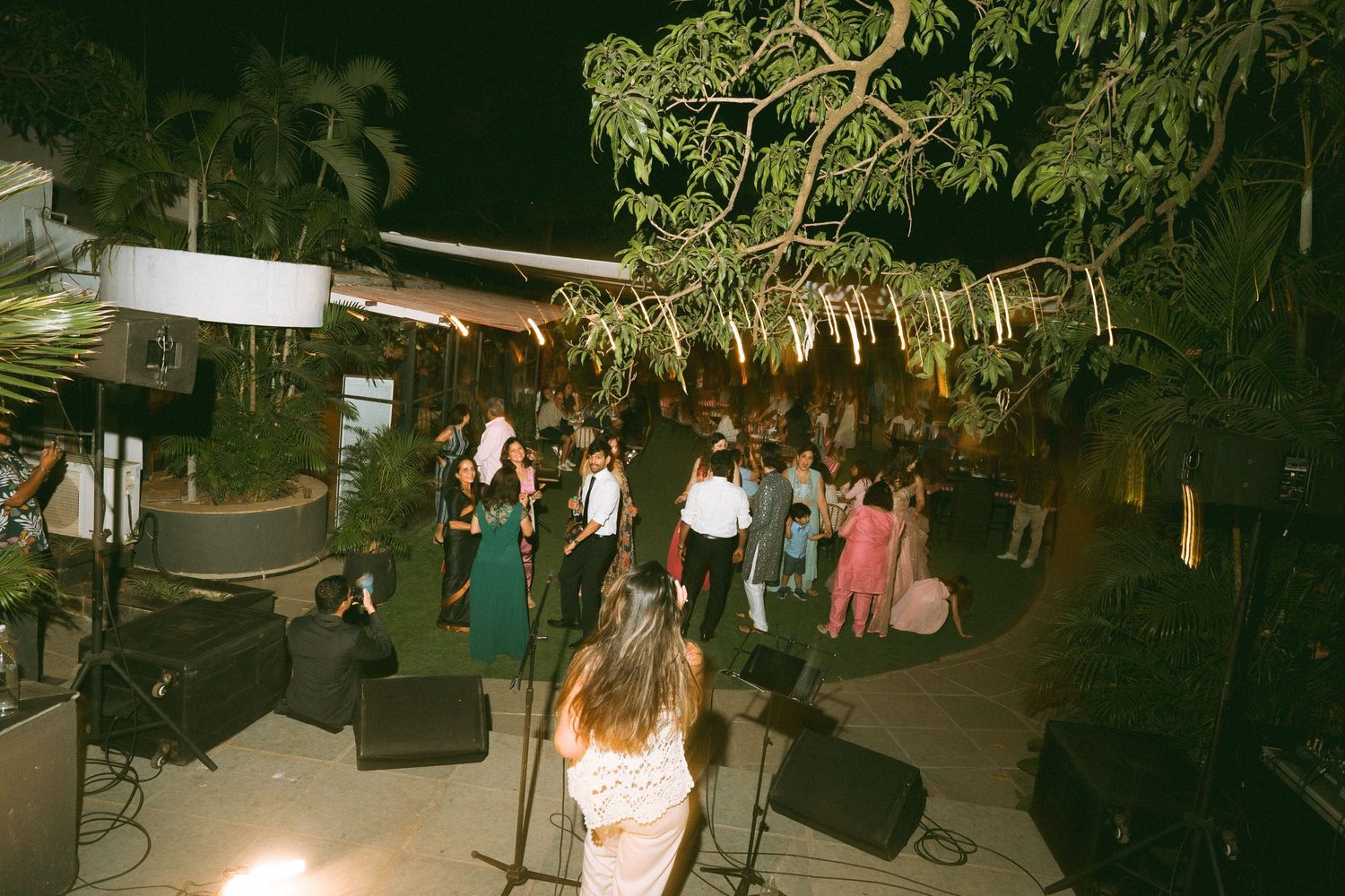 Outdoor wedding reception with dance floor & string lights beautifully set up and captured by a wedding photographer in London