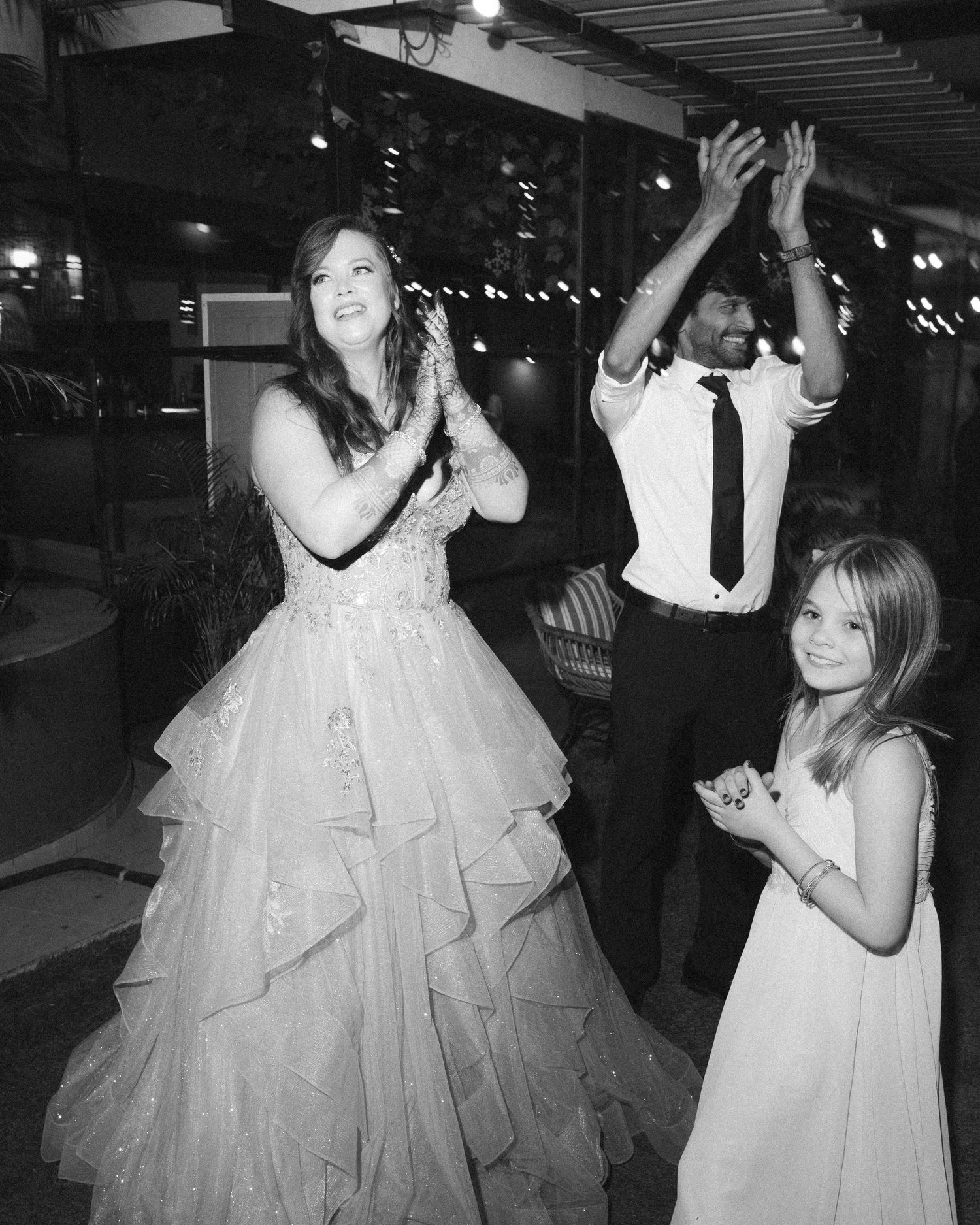 Dancing couple in formal attire with bride in a layered white ballgown by the best wedding photographer in London & Birmingham.