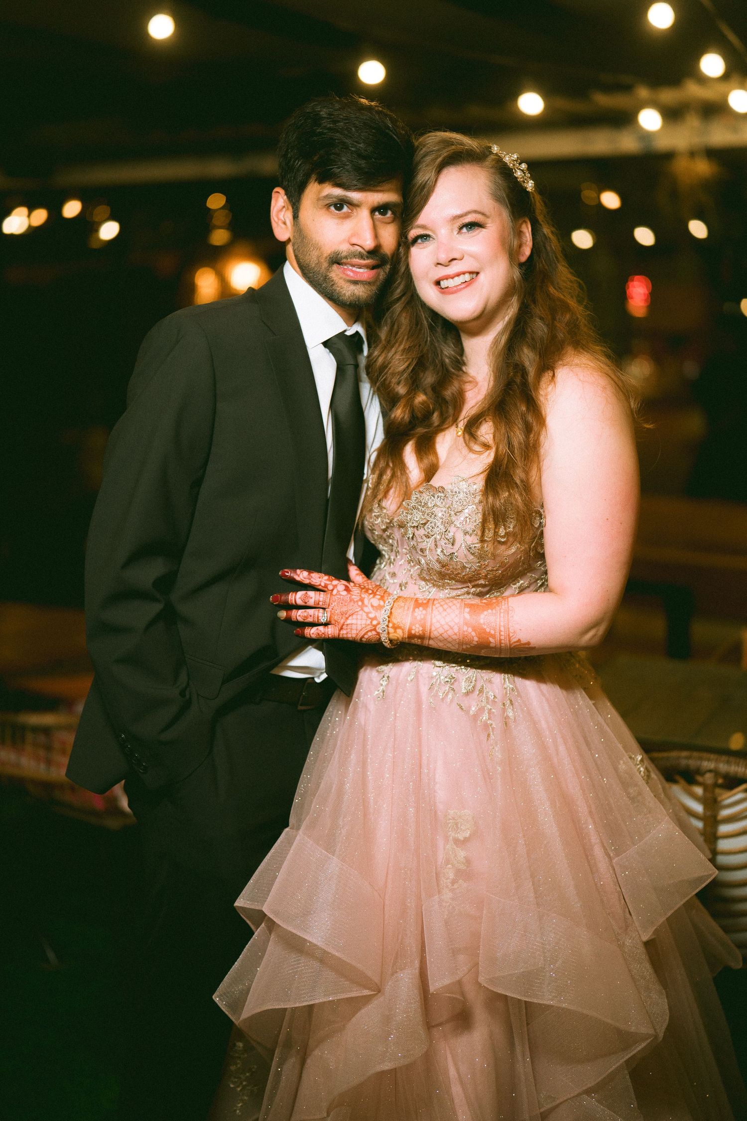 Couple posing at night with the bride in a sparkly pink tulle gown by the best wedding photographer near me in London & Birmingham.