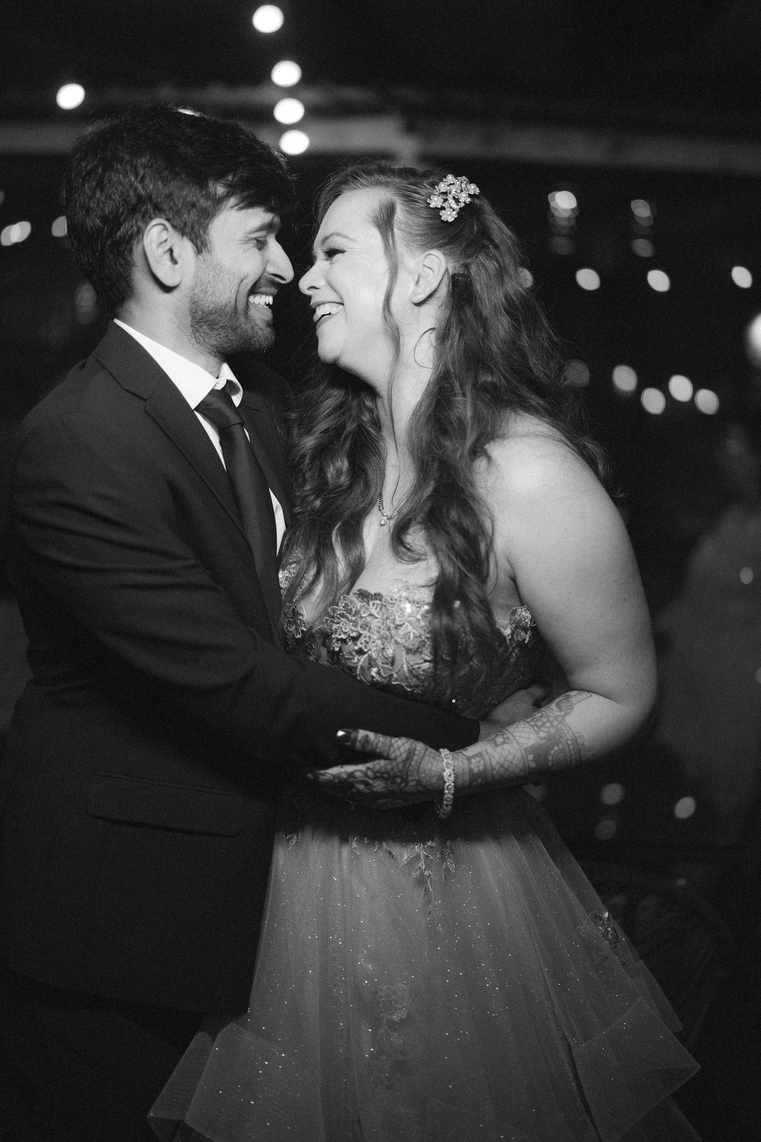 Couple sharing an intimate dance moment under dim lighting at an evening wedding by the best wedding photographer in London.