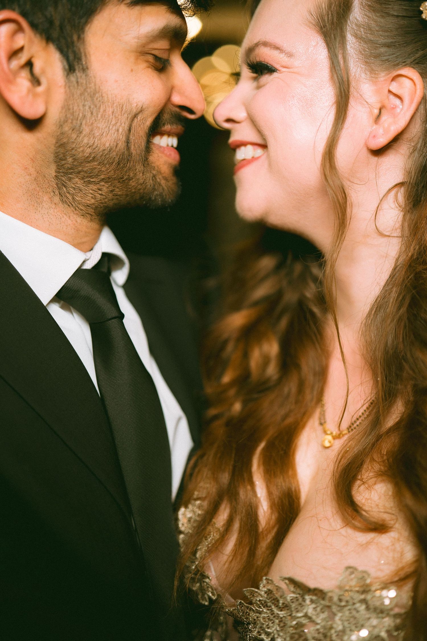 Couple sharing intimate close-up moments during a formal evening wedding celebration by the best wedding photographer in London.