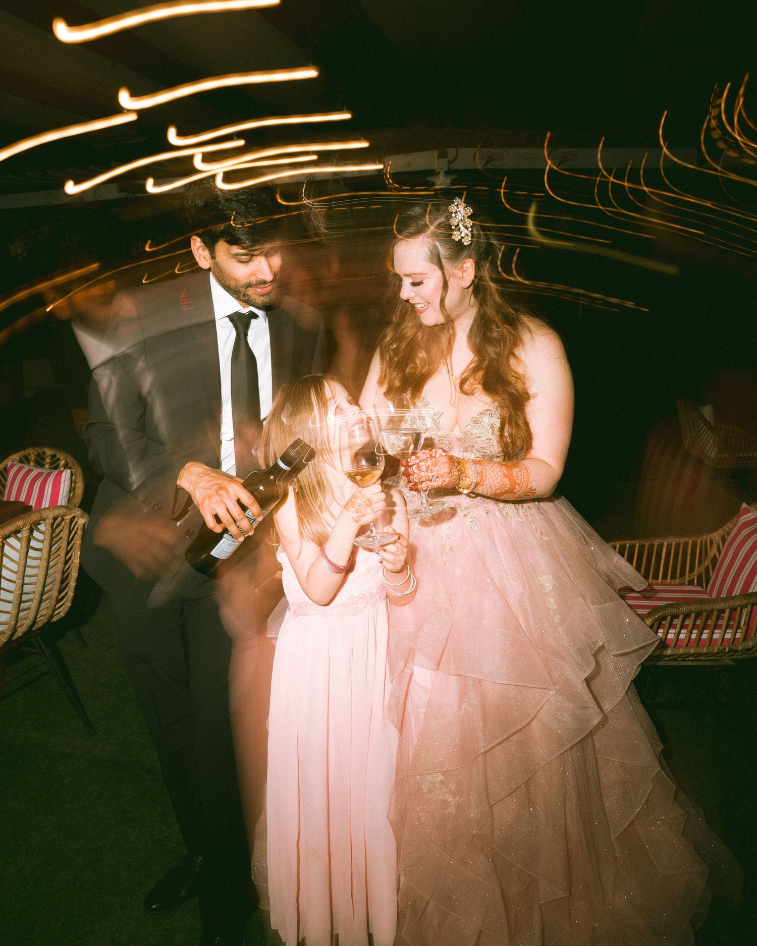 Thought for 1sWedding guests gathered for evening festivities in warm ambient lighting — by the best wedding photographer in London