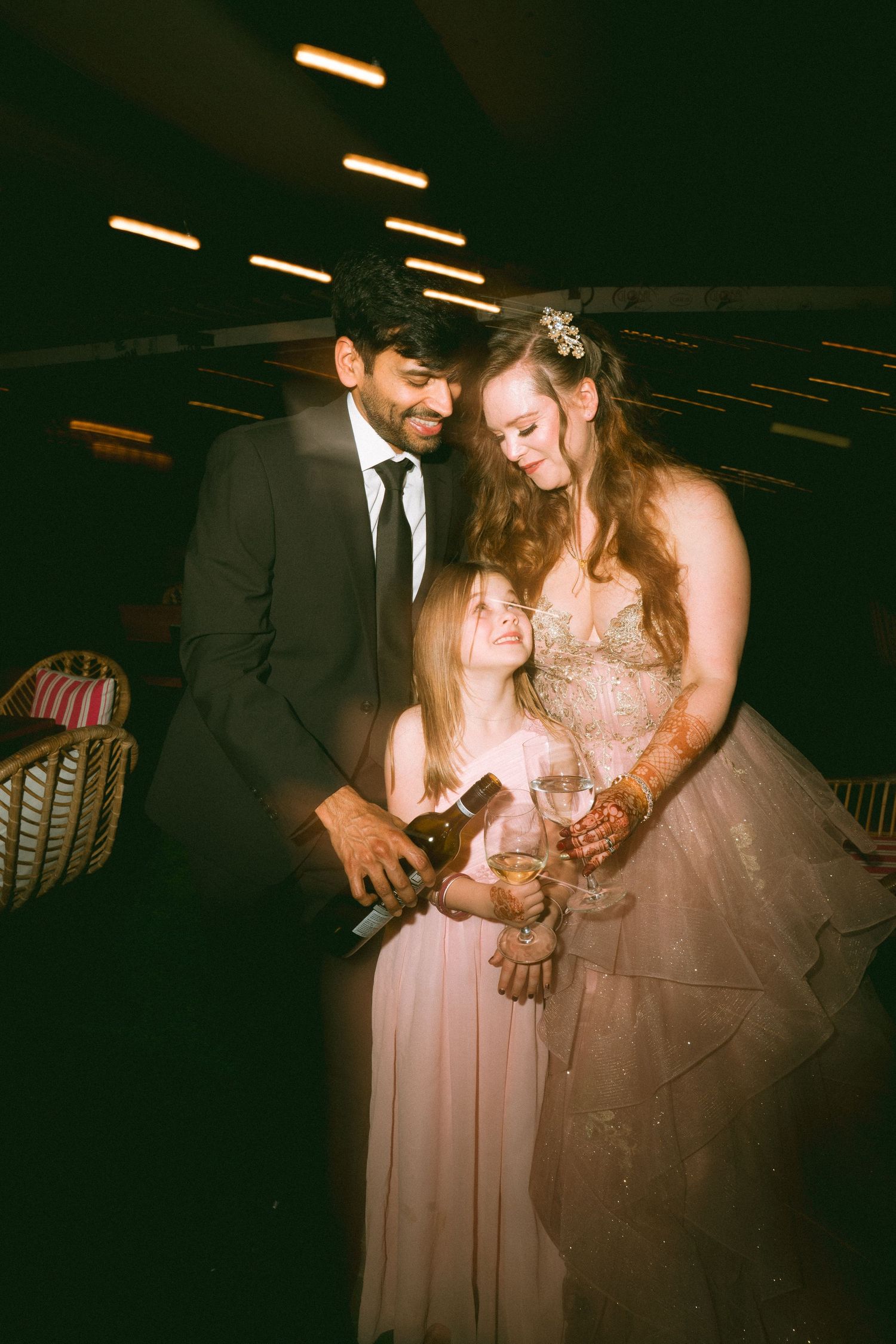 Thought processWedding guests in formal attire sharing joyful moments at an evening reception by best wedding photographer in London
