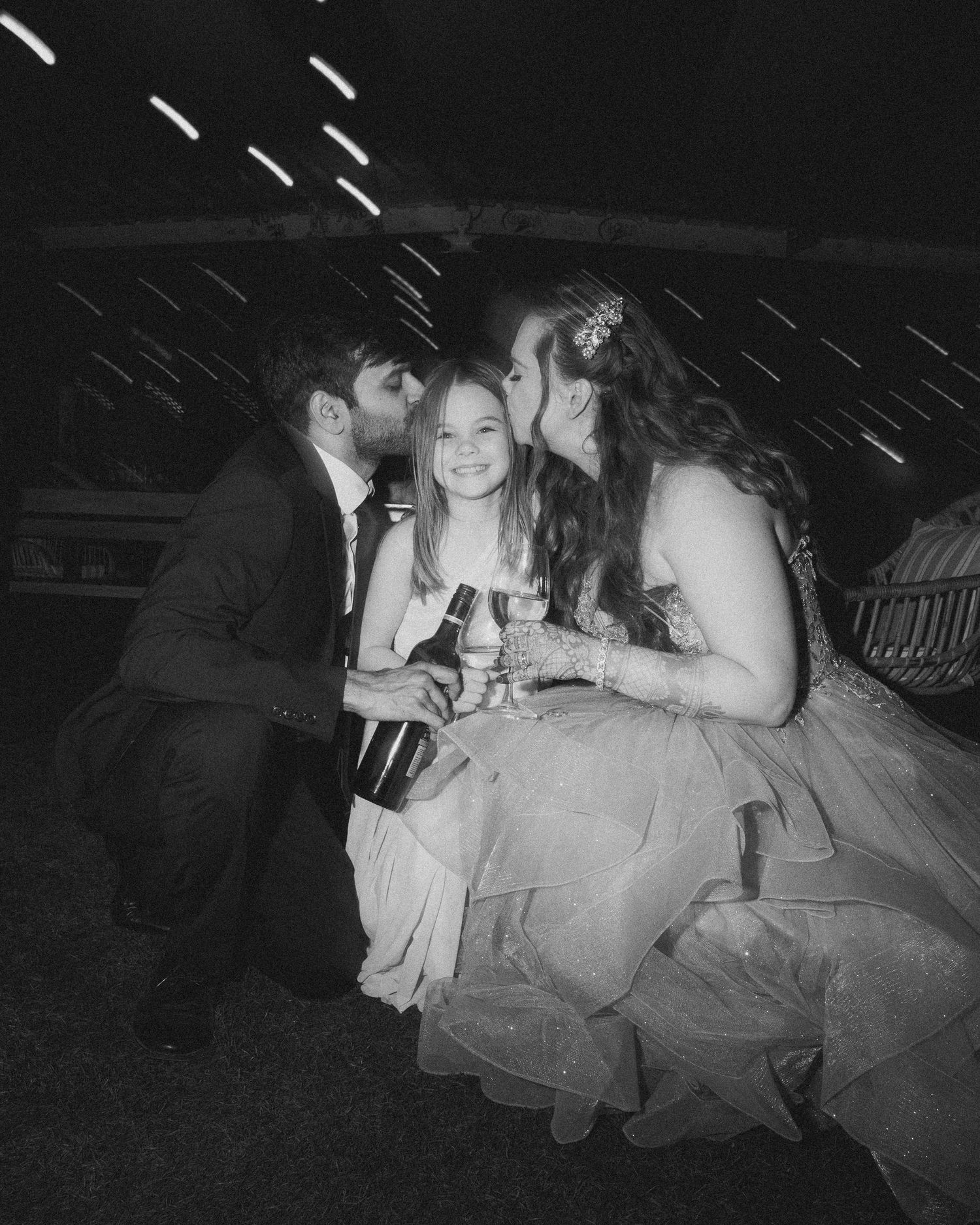 Black & white photo capturing intimate moments between wedding guests at evening reception by best wedding photographer in London