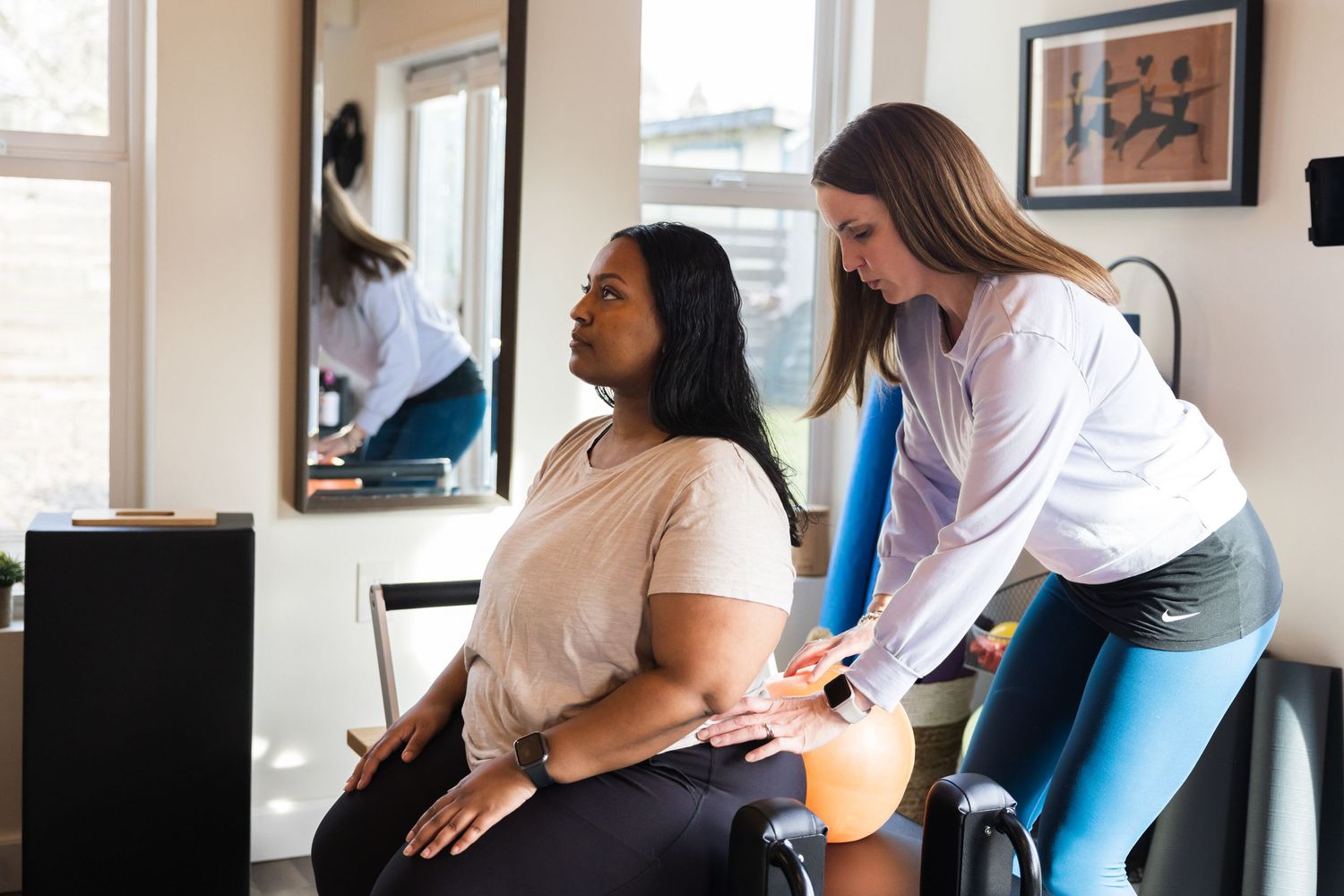 A healthcare provider assists a patient during a physical therapy session at a medical office.