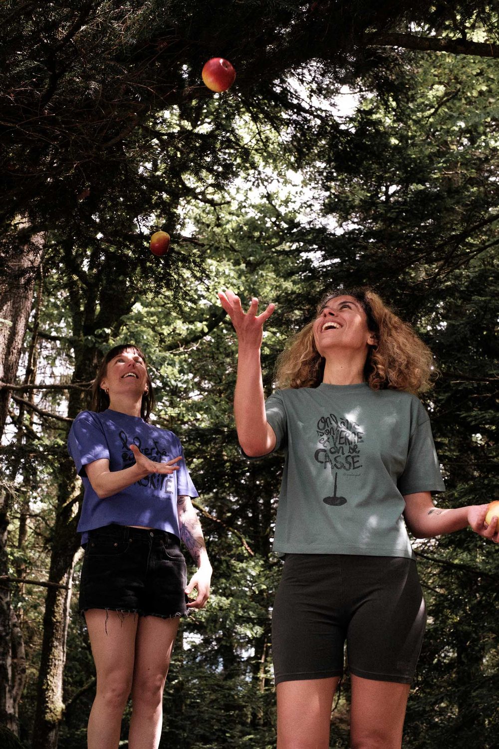 People playing with colorful juggling balls in a forest setting.