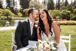 couple happy after sighing the marriage certificate