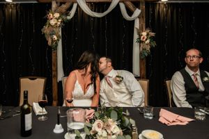 couple kissing during reception