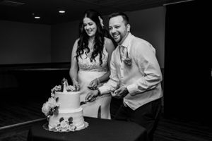 black and white picture of couple cake cutting