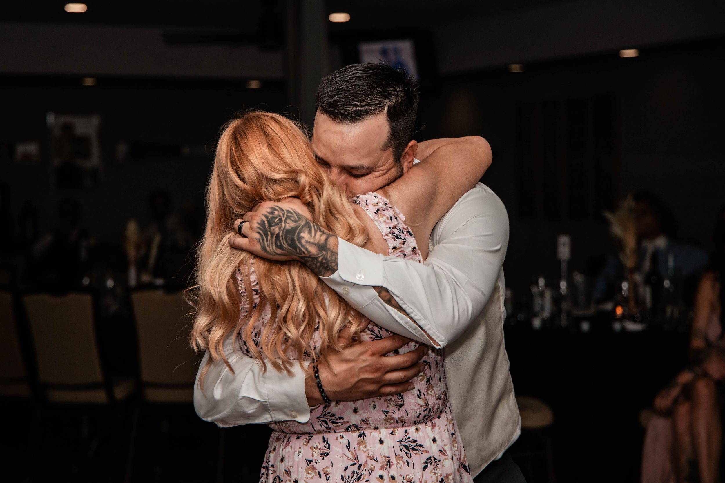 groom hugging his mom during first dance with mom
