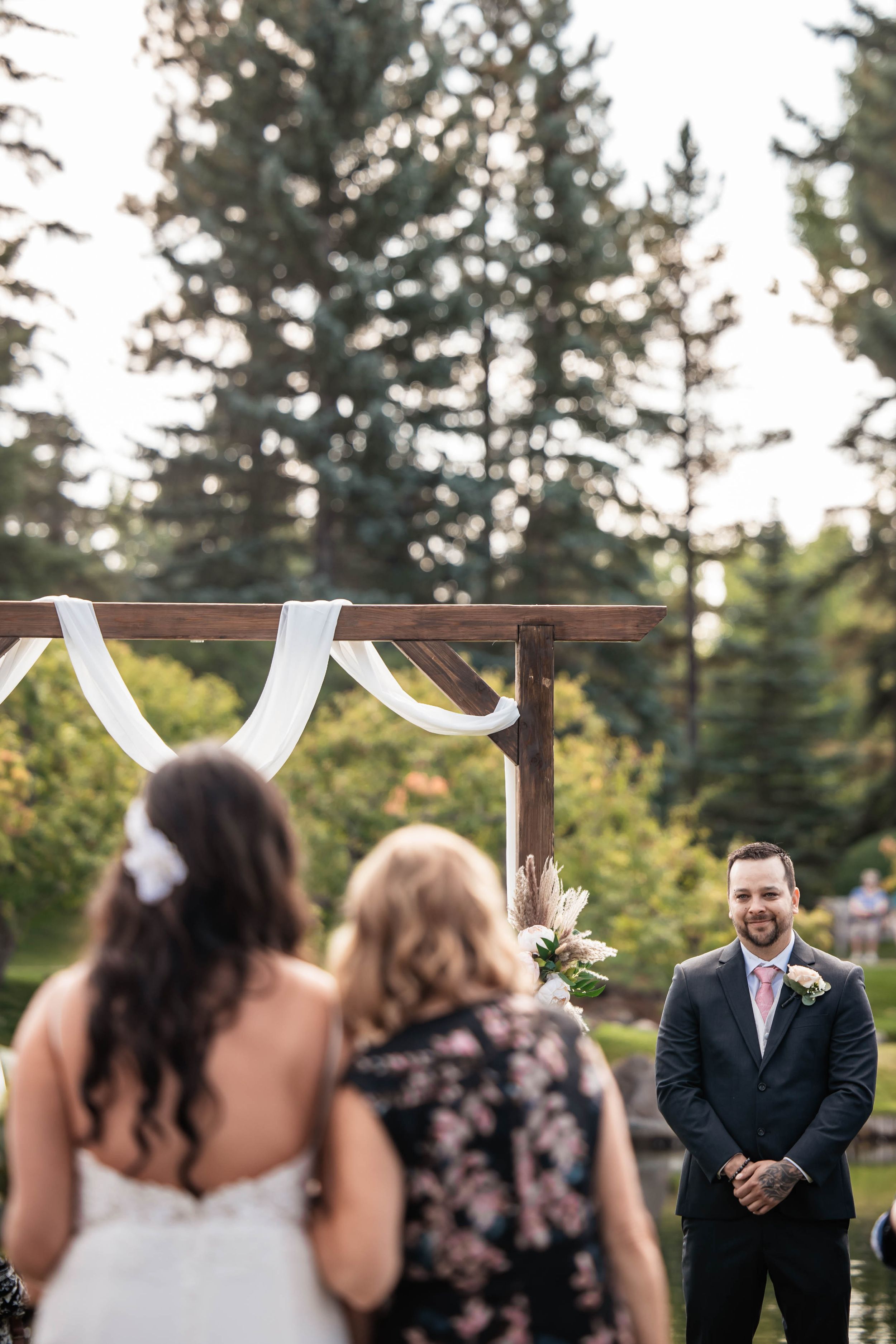 bride walking down the aisle and grooms reaction