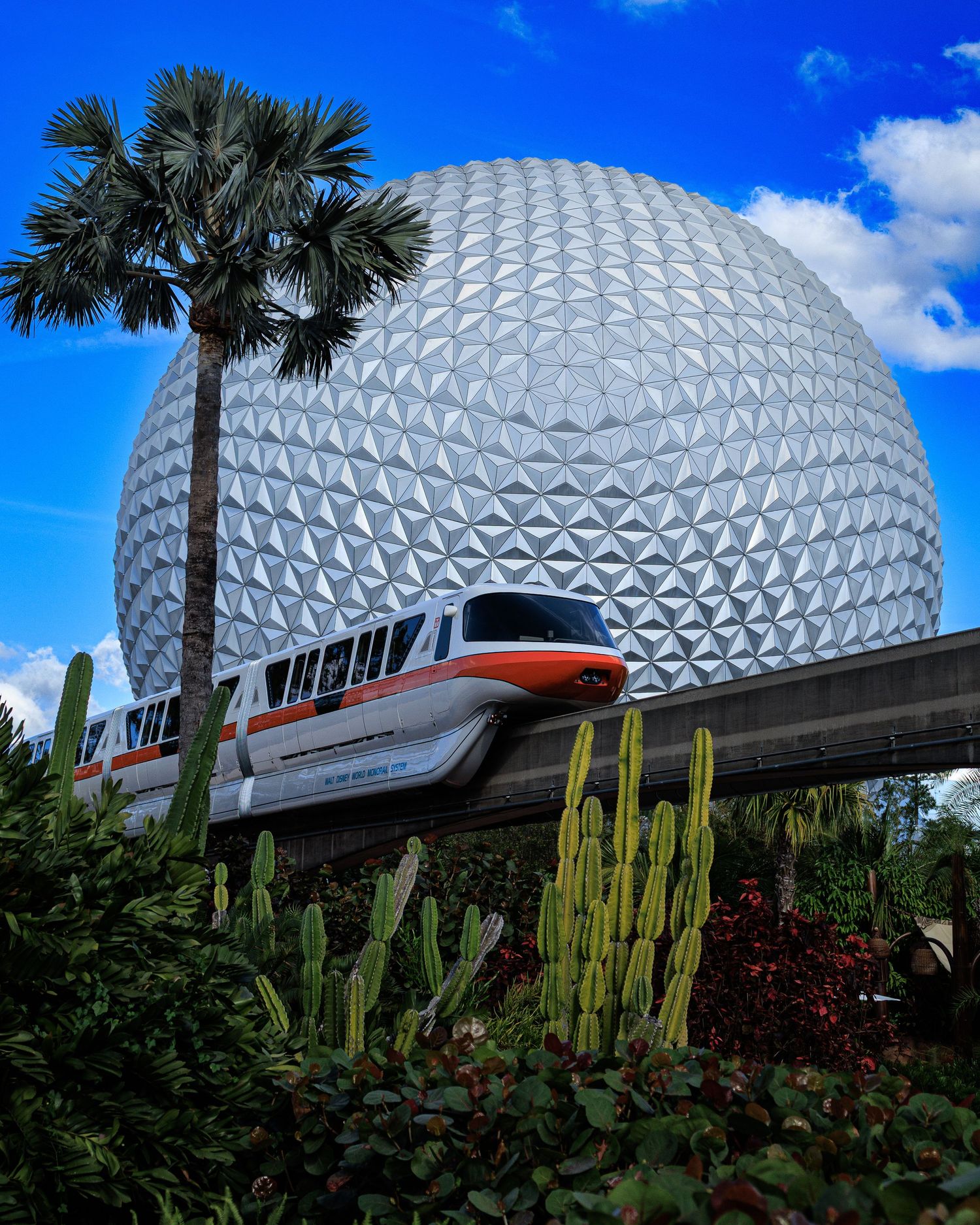 Disney's Epcot Center monorail passes in front of the iconic Spaceship Earth geodesic sphere.