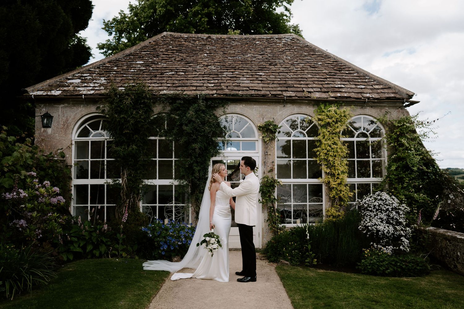 groom adjusting brides hair at hamswell house wedding in bath