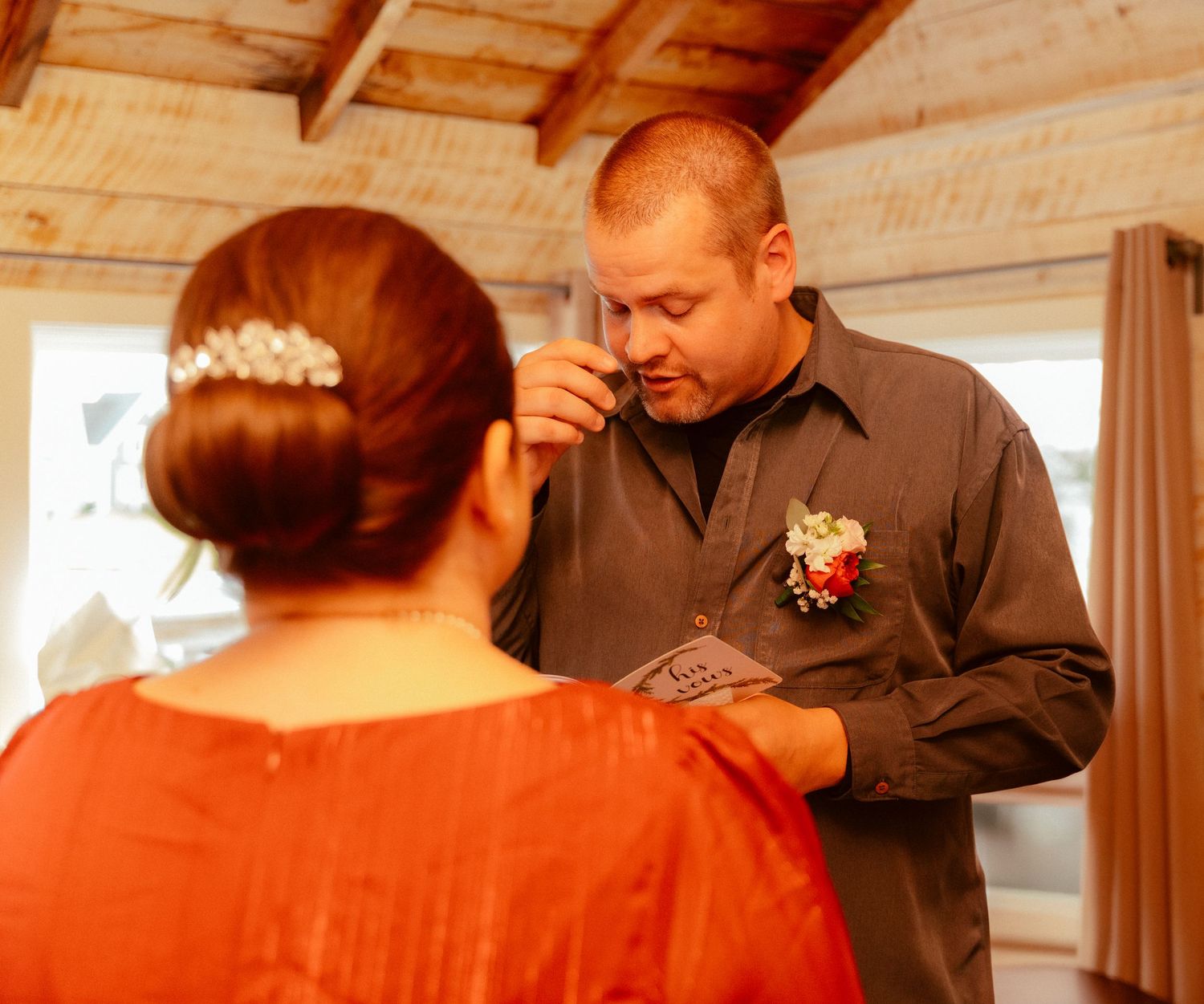 A tender moment between two people exchanging letters in a wooden cabin.