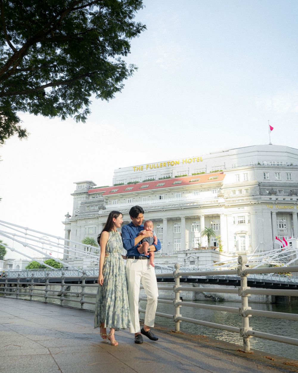 Family portrait in front of the grand Fullerton Hotel during golden hour.