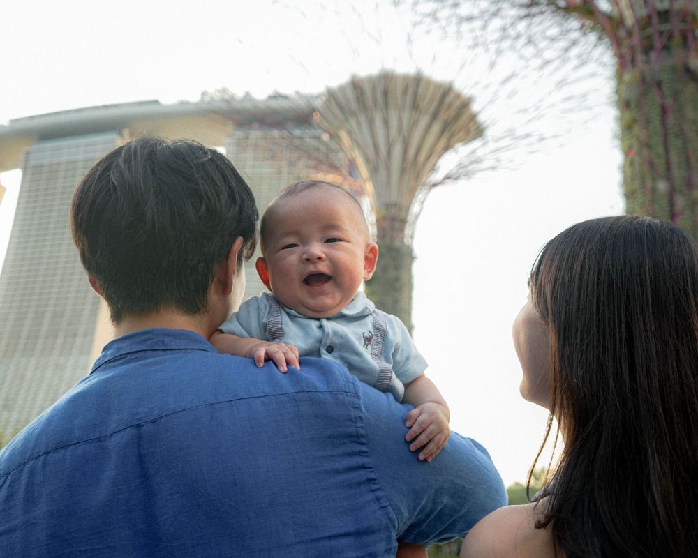 Happy baby laughs while being held up at Gardens by the Bay Singapore.