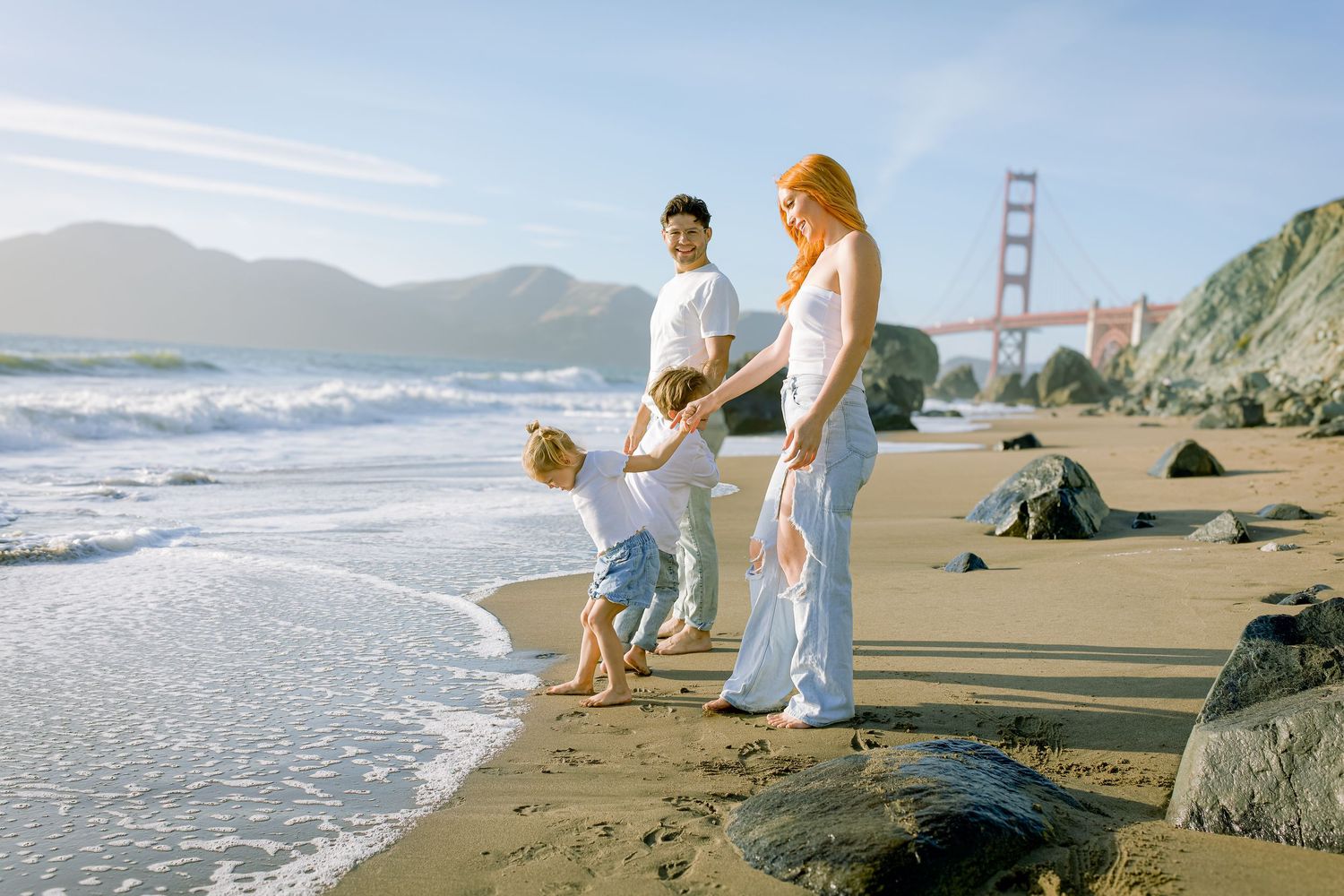 San Francisco Family photo shoot by the Golden Gate Bridge. Capturing family fun during beach golden hour