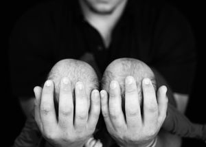 Dad holding twin babies black and white photo. #RoswellNM #TwinNewbornPhotographer #ArtesiaNM #carlsbadNM #NewbornPhotography