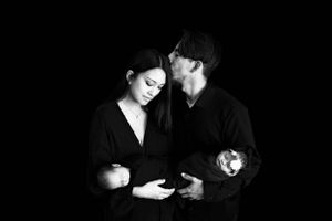 A couple in black clothing shares a tender moment in black and white fine art photography. #TwinNewbornSession #TwinNewbornphotographer