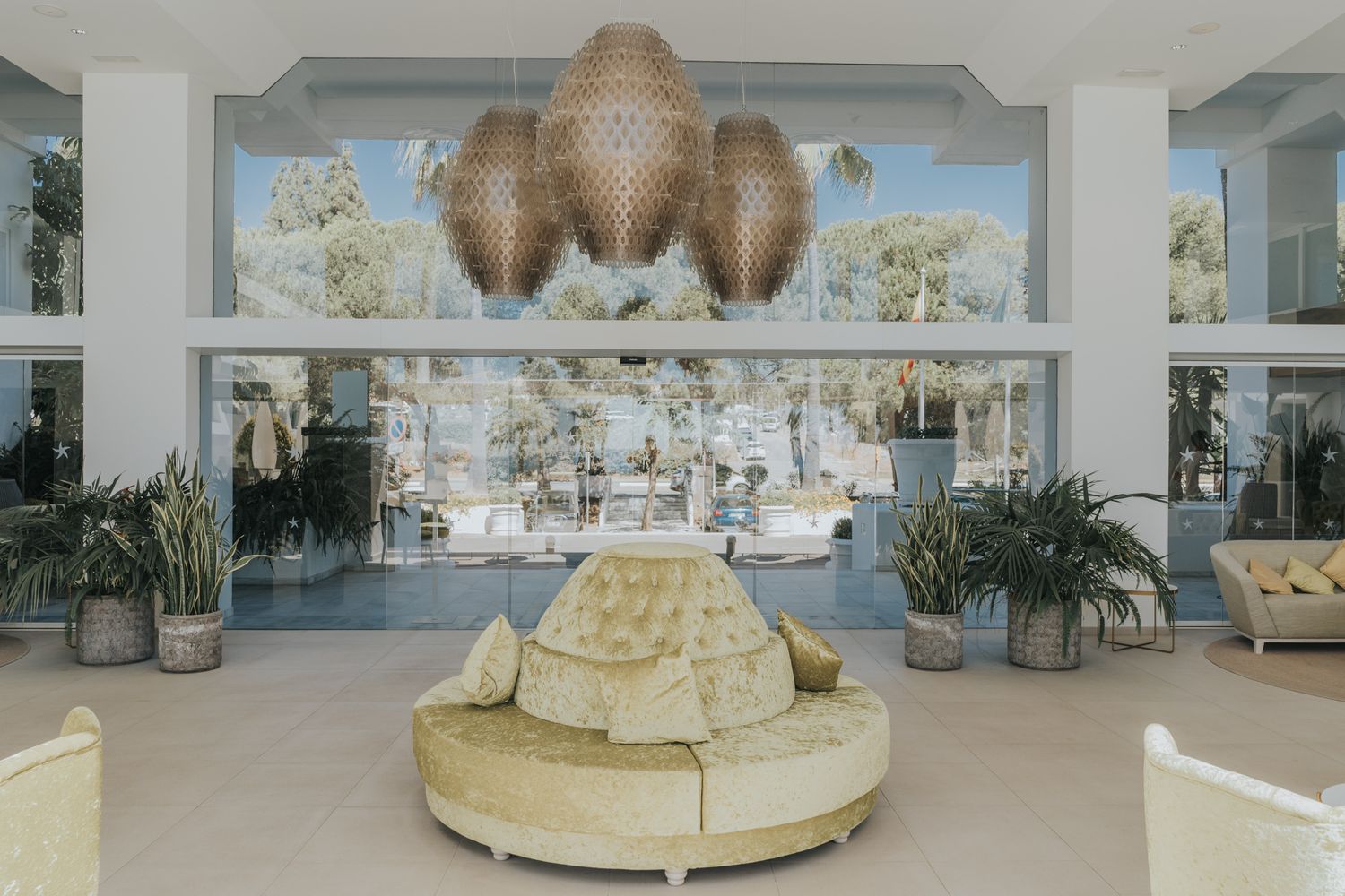 Modern wedding venue interior with circular seating and dramatic woven chandelier.