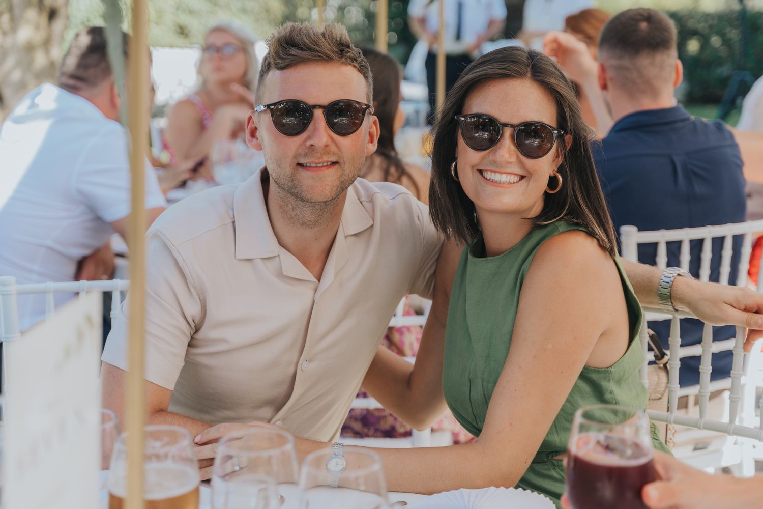 Guests enjoying drinks and conversation at an outdoor wedding reception.
