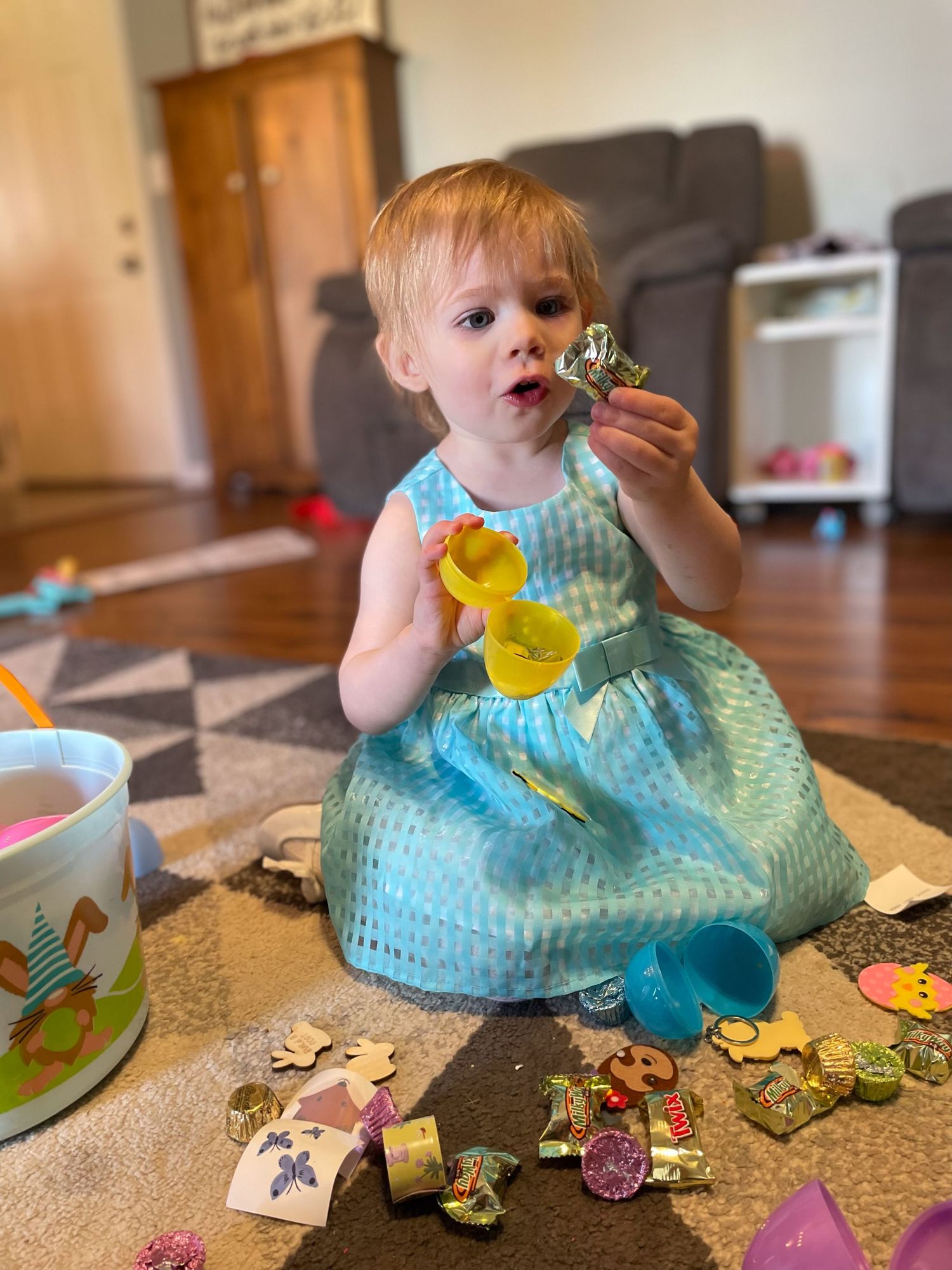 Springfield, IL family photographer shows insight to her life with a picture of her daughter opening Easter eggs on Easter.