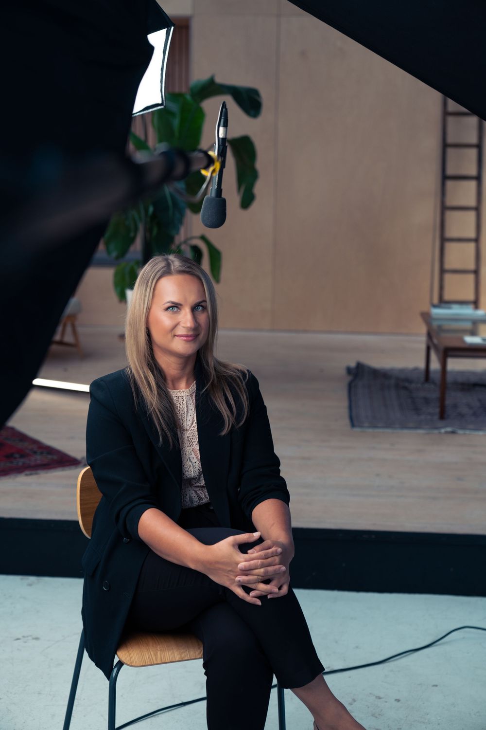 Professional interview setting with person seated in modern studio space.