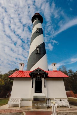 The St. Augustine Lighthouse in Florida features distinctive black and white spiral stripes and a red-roofed keeper's house.