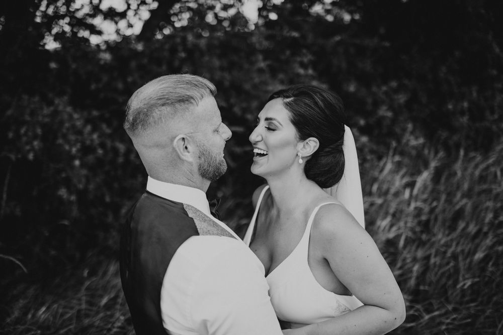 Bride and groom portraits having a great time smiling