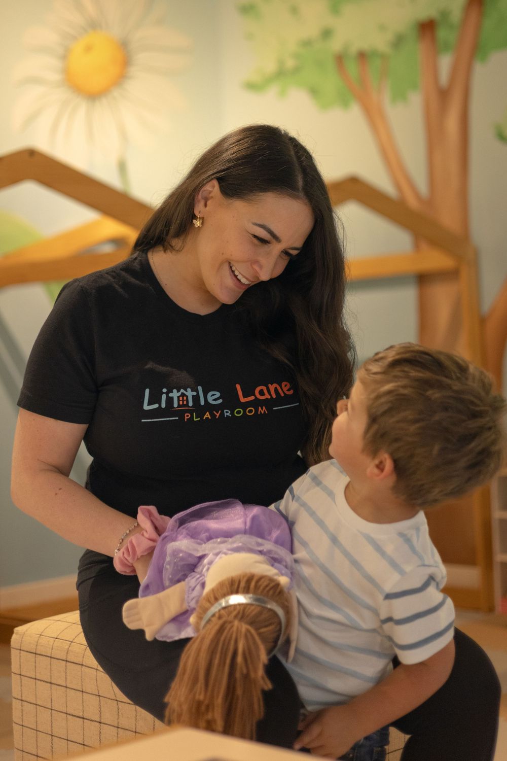 Mom warmly looking and smiling at little boy, as he look up at her doing the same in a moment of bonding and happiness in Escondido, CA.