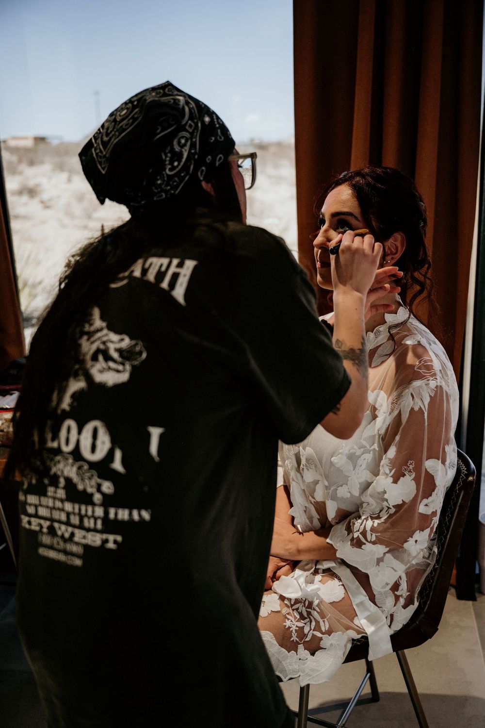 Wedding preparation scene with white lace details in a sunlit room.