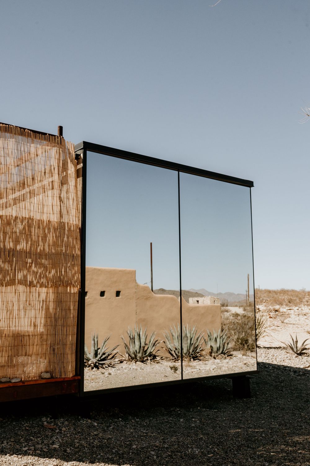 Modern desert architecture featuring minimalist walls and desert landscape views.