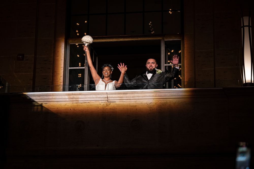 Dark reception venue illuminated with string lights creating a romantic atmosphere.
