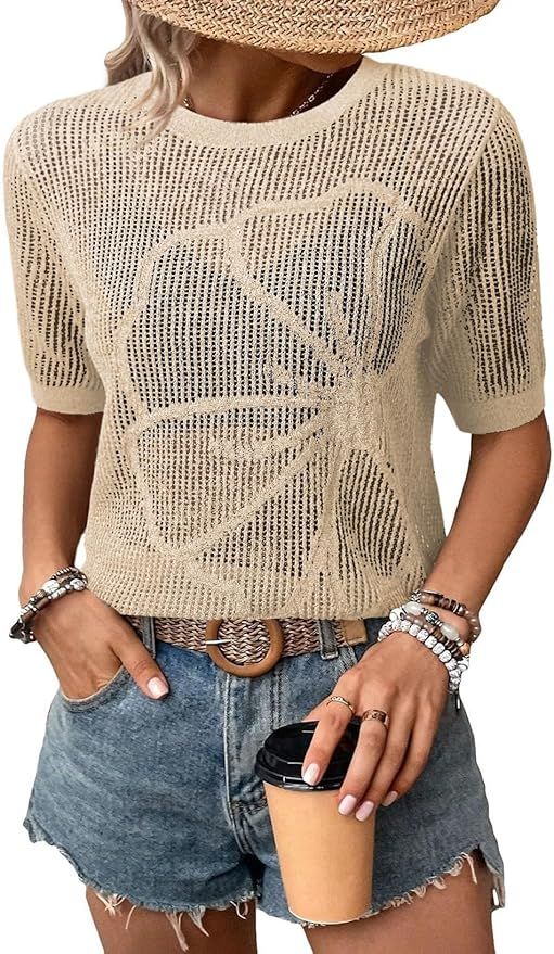 Cropped view of a beige crochet mesh top paired with distressed denim shorts and silver accessories.