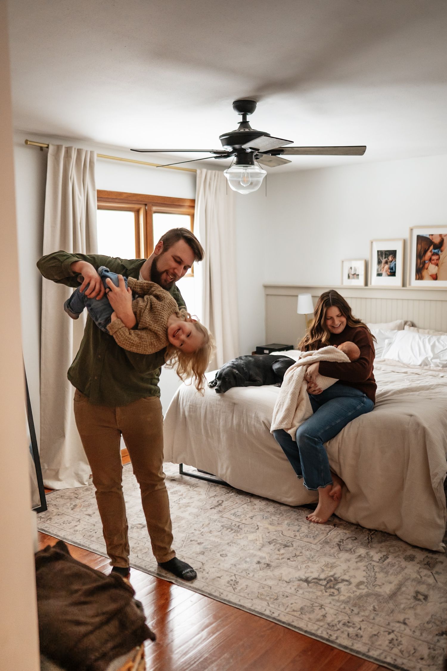 A playful sequence showing a couple having fun and being silly together on a beige carpet in a bright bedroom.