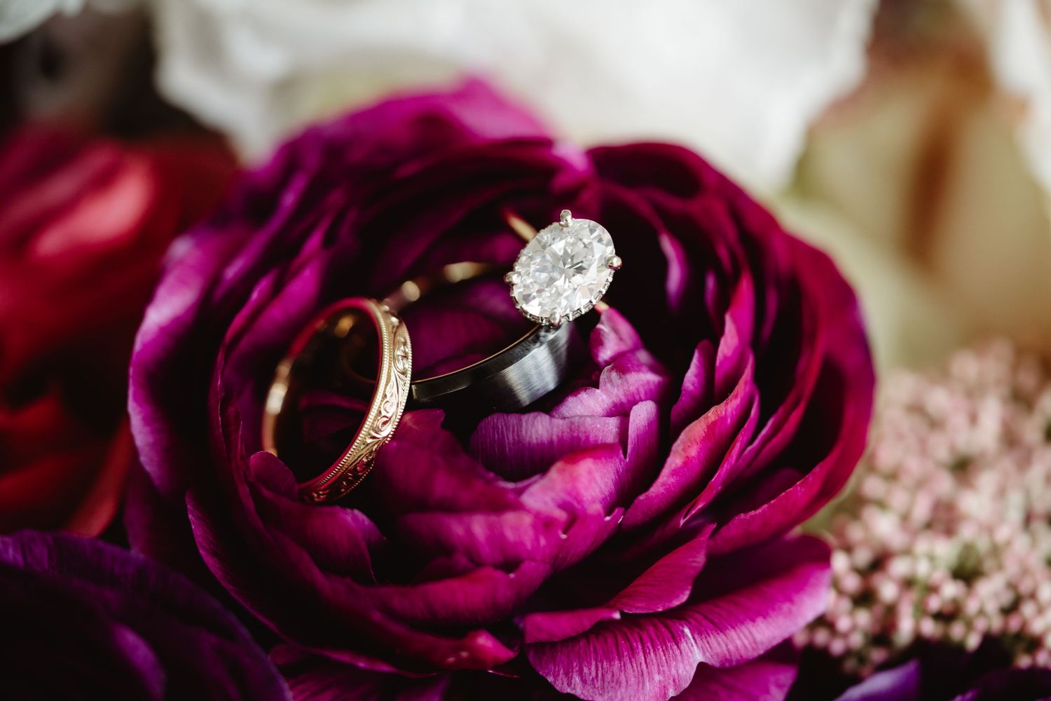 A couple shares a romantic moment in a lush garden setting during their wedding celebration.
