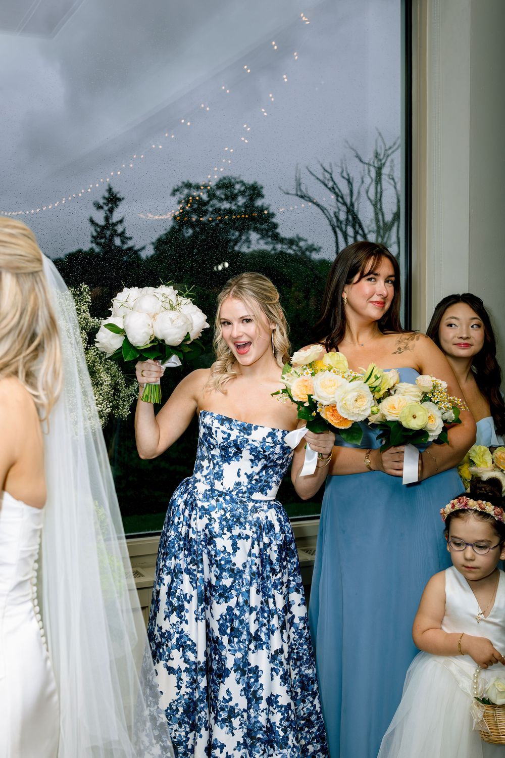 Bridesmaids in blue floral and solid dresses share candid laughing moments in a sequence of wedding party photos.
