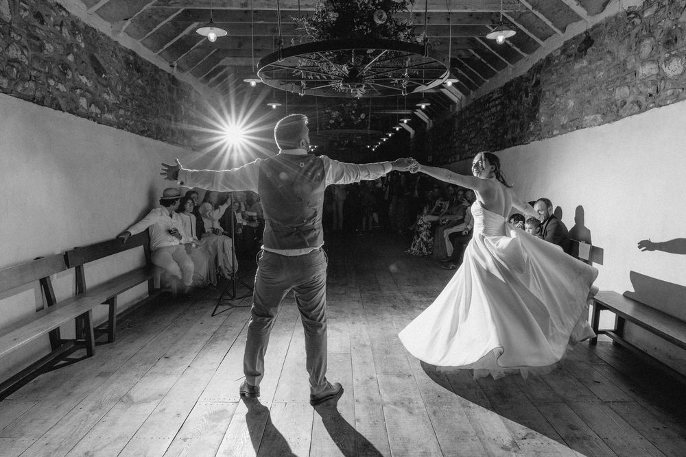 Black and white photo montage of a couple dancing together at a wedding reception in an elegant venue.