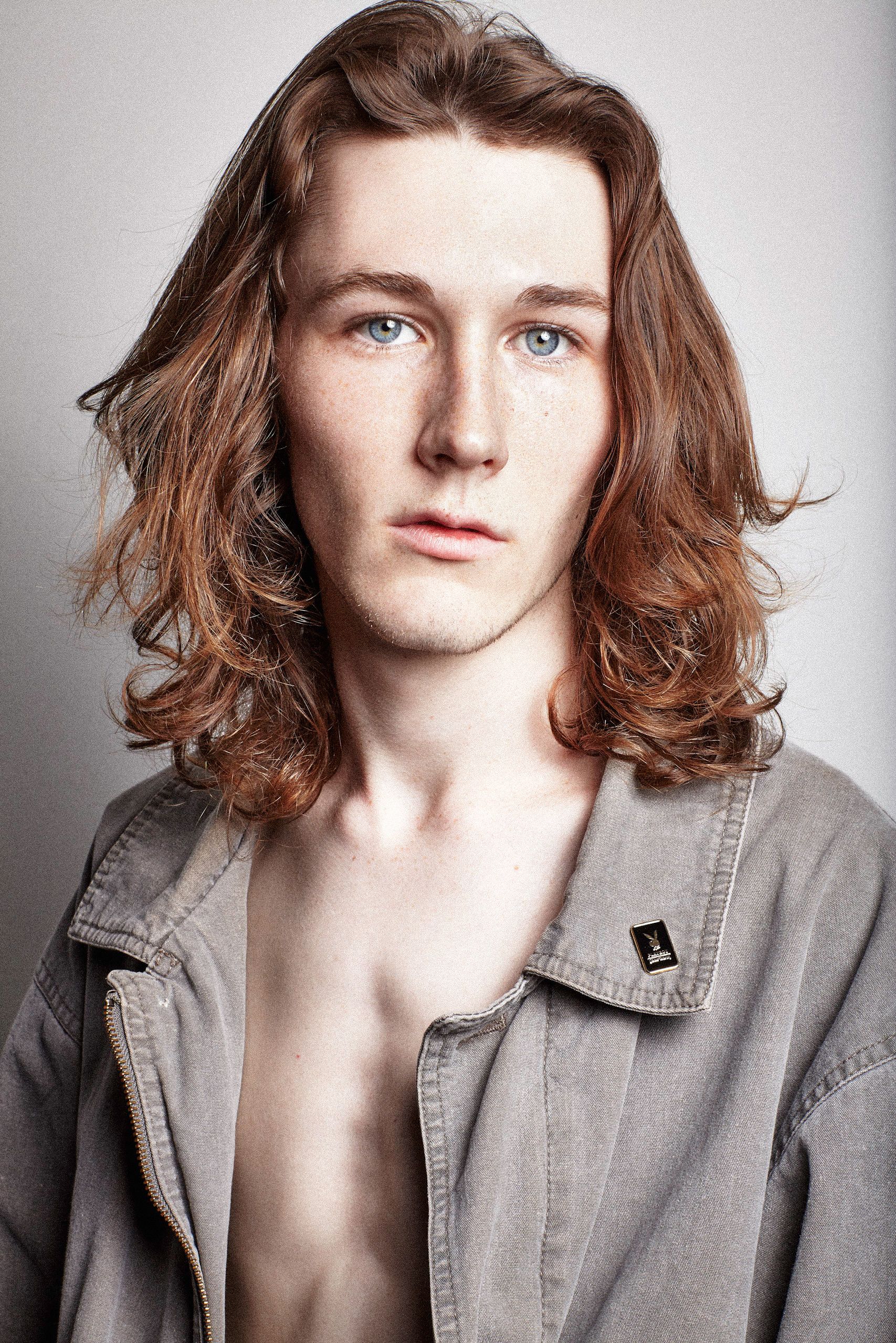 A series of profile portraits showing a person with wavy auburn hair wearing a gray collared shirt against a light background.