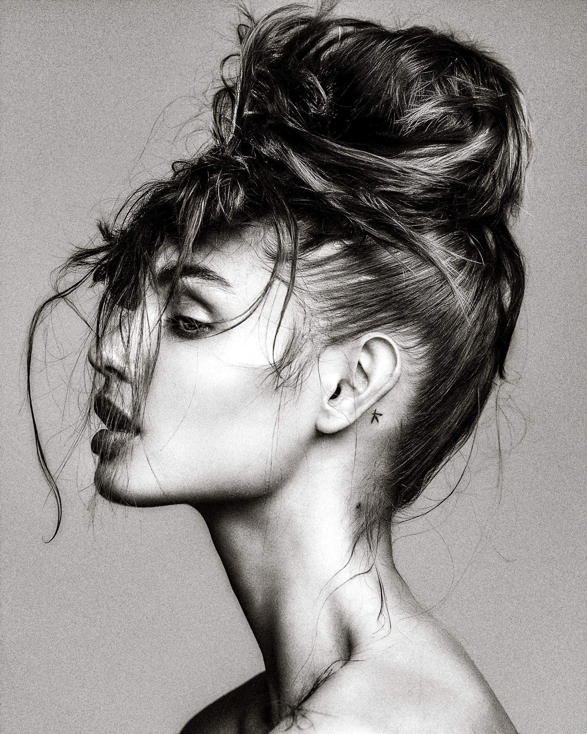 Black and white artistic portrait series showing profile views with messy updo hairstyle and dramatic shadows.