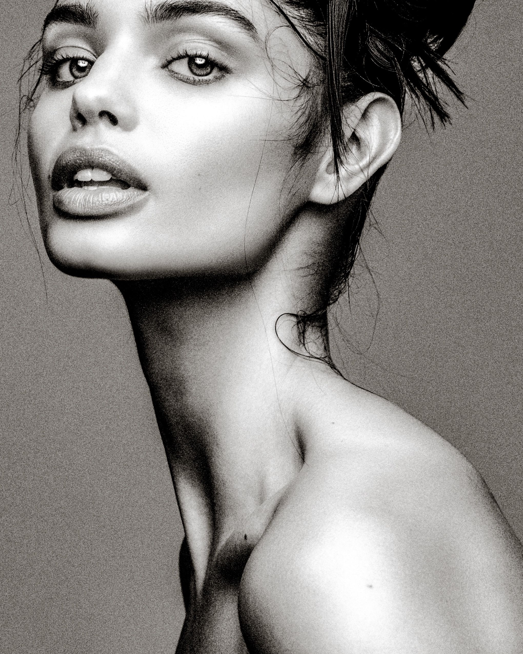 A black and white artistic fashion portrait series showing dramatic angles and lighting of a model in minimalist style.