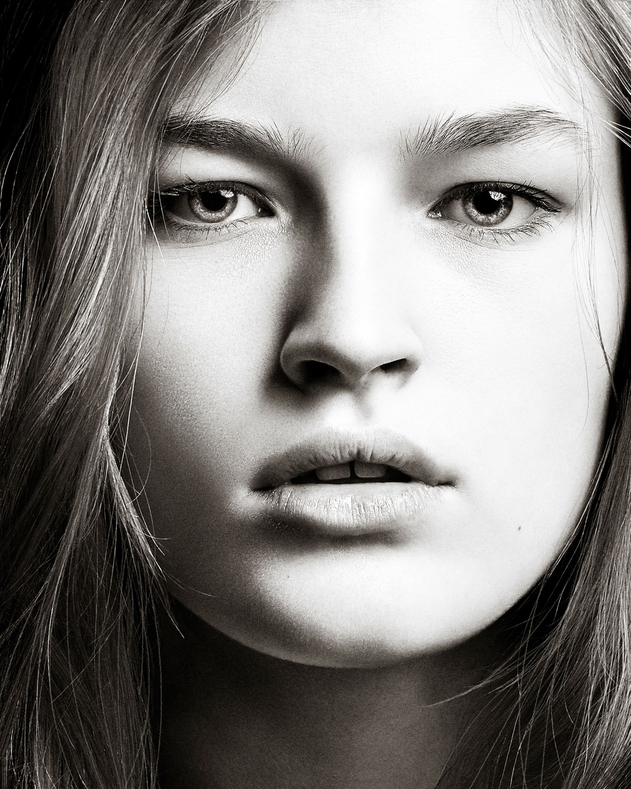 A series of black and white close-up portraits showing dramatic lighting and shadows.