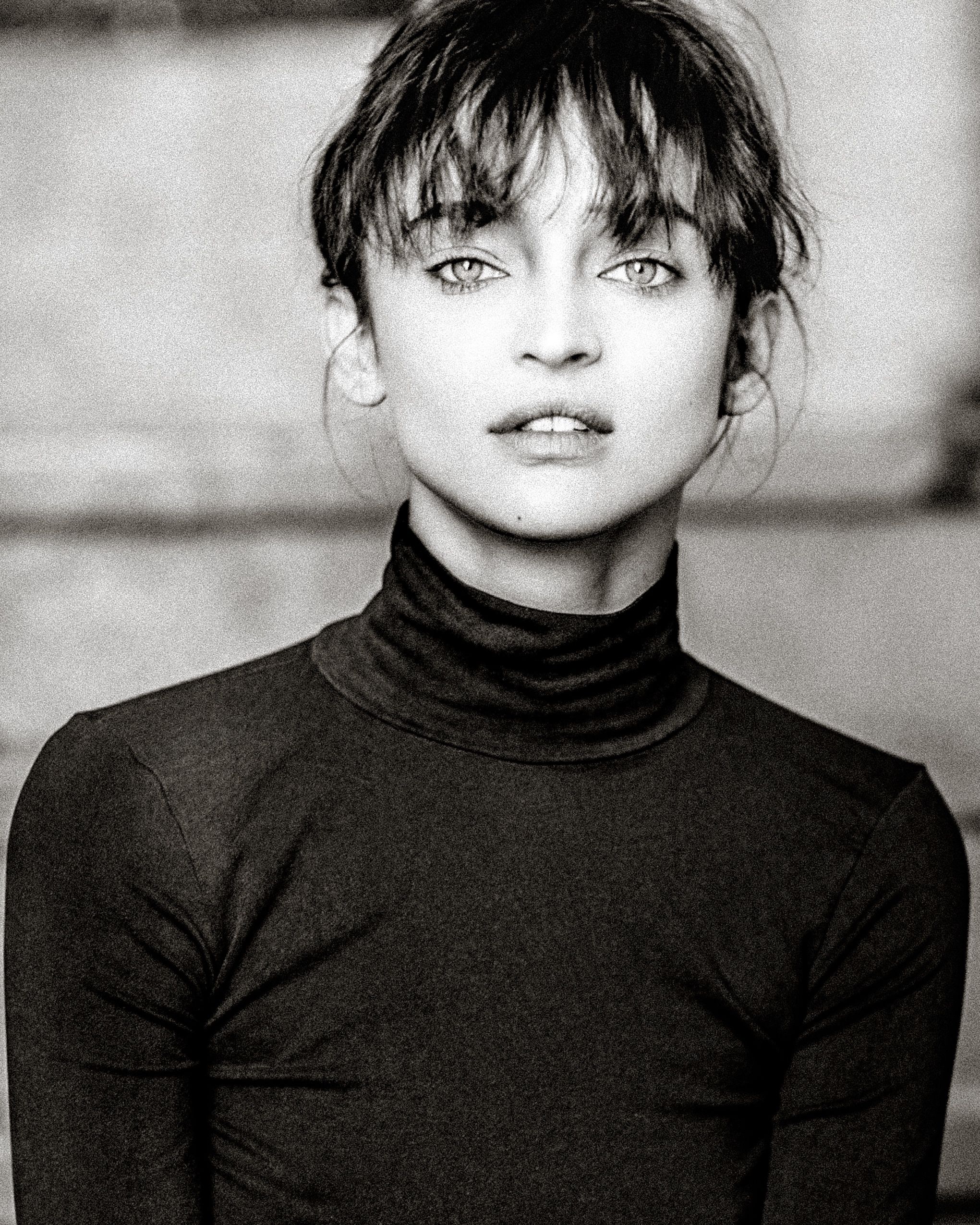 Black and white portrait series showing a person in a black turtleneck making different facial expressions.