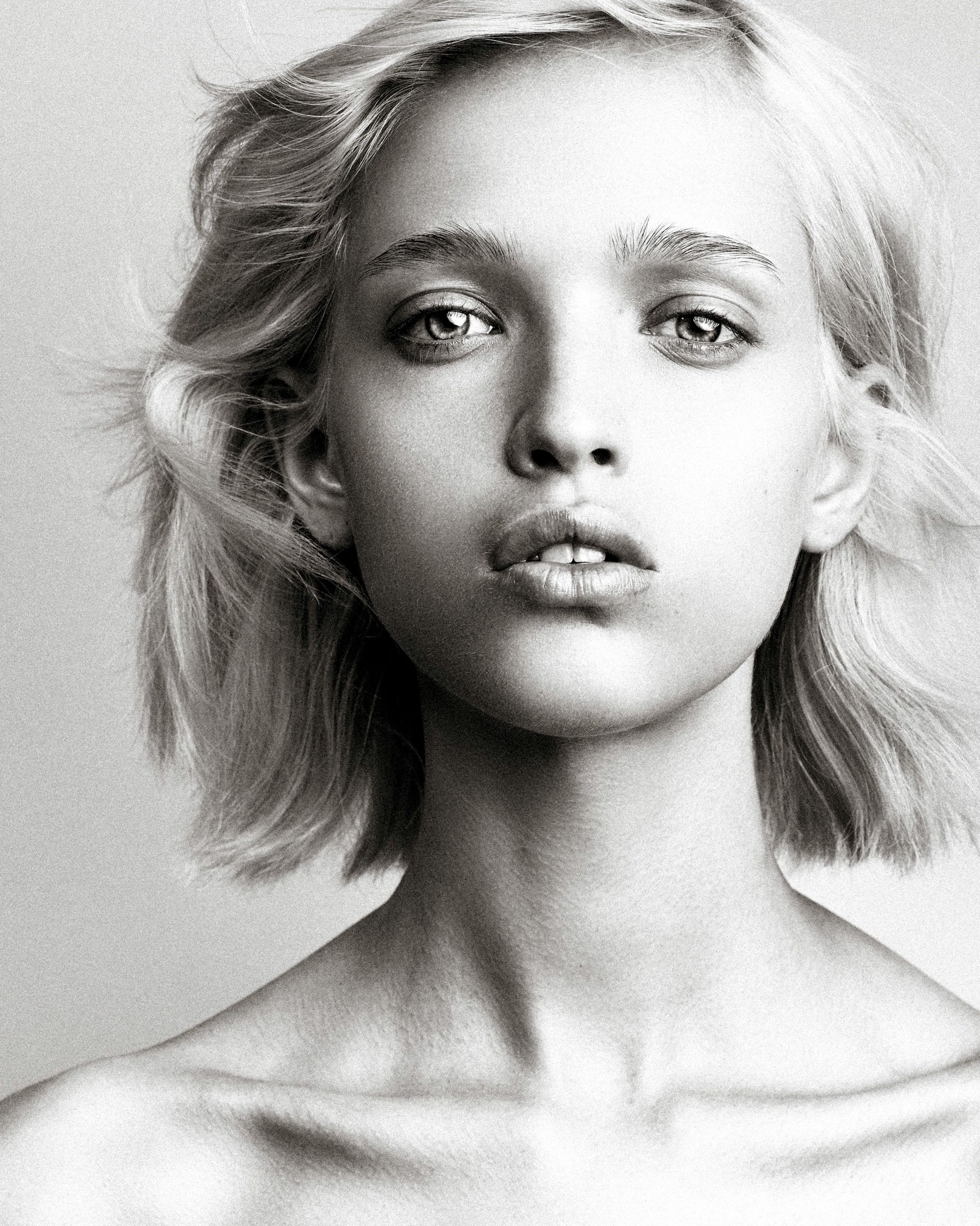 Black and white portrait sequence showing a person with blonde hair making various expressive poses.